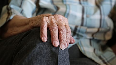An elderly man's hand.