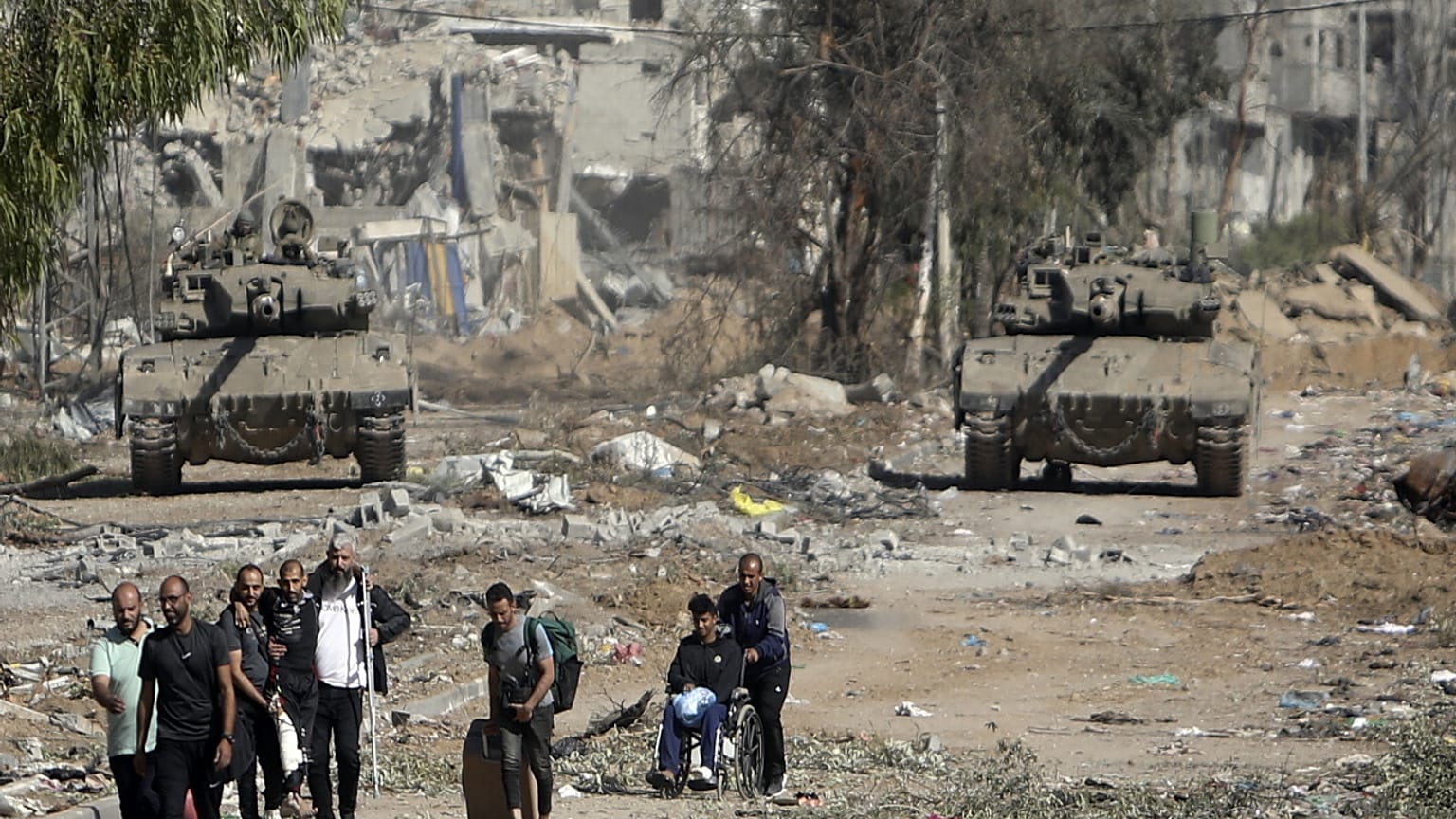 Palestinians flee to northern Gaza as Israeli tanks block the Salah al-Din road in the central Gaza Strip on Nov. 24, 2023