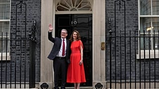 Britain's Labour Party Prime Minister Keir Starmer and his wife Victoria waves to the crowds of supporters and media from the doorstep of 10 Downing Street in London, Friday,