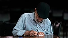 An Iranian man fills out his ballot for the presidential runoff election at a polling station in Tehran, 5 July 2024