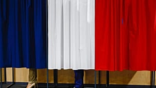Fransa Cumhurbaşkanı Emmanuel Macron ve eşi Brigitte Macron, 30 Haziran 2024 Pazar günü Fransa'nın kuzeyindeki Le Touquet-Paris-Plage'de oy kullanmadan önce oy kabininde duruyor. (Yara 