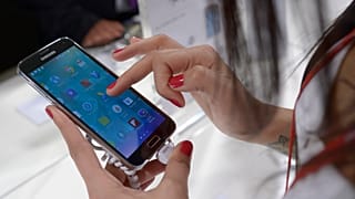 A woman uses a Samsung phone in Barcelona, Spain. 