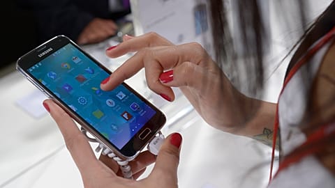 A woman uses a Samsung phone in Barcelona, Spain. 
