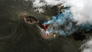 This colour infrared image released by Maxar Technologies shows lava flowing from the Mount Etna volcano erupting, in Sicily, Italy on Thursday