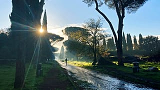 A man jogs on the ancient roman Appian Way in Rome