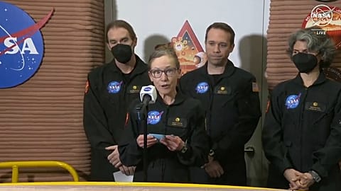 Kelly Haston, a crew member of the first CHAPEA mission, speaks in front of other members  at Johnson Space Center in Houston, Texas.