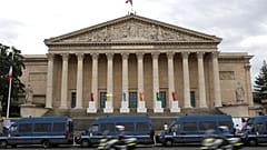 Police vans park outside the National Assembly during the second round of the legislative elections, Sunday, July 7, 2024 in Paris. 