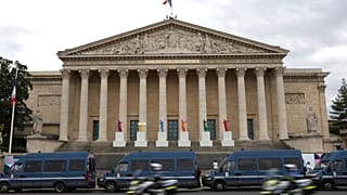 Police vans park outside the National Assembly during the second round of the legislative elections, Sunday, July 7, 2024 in Paris. 