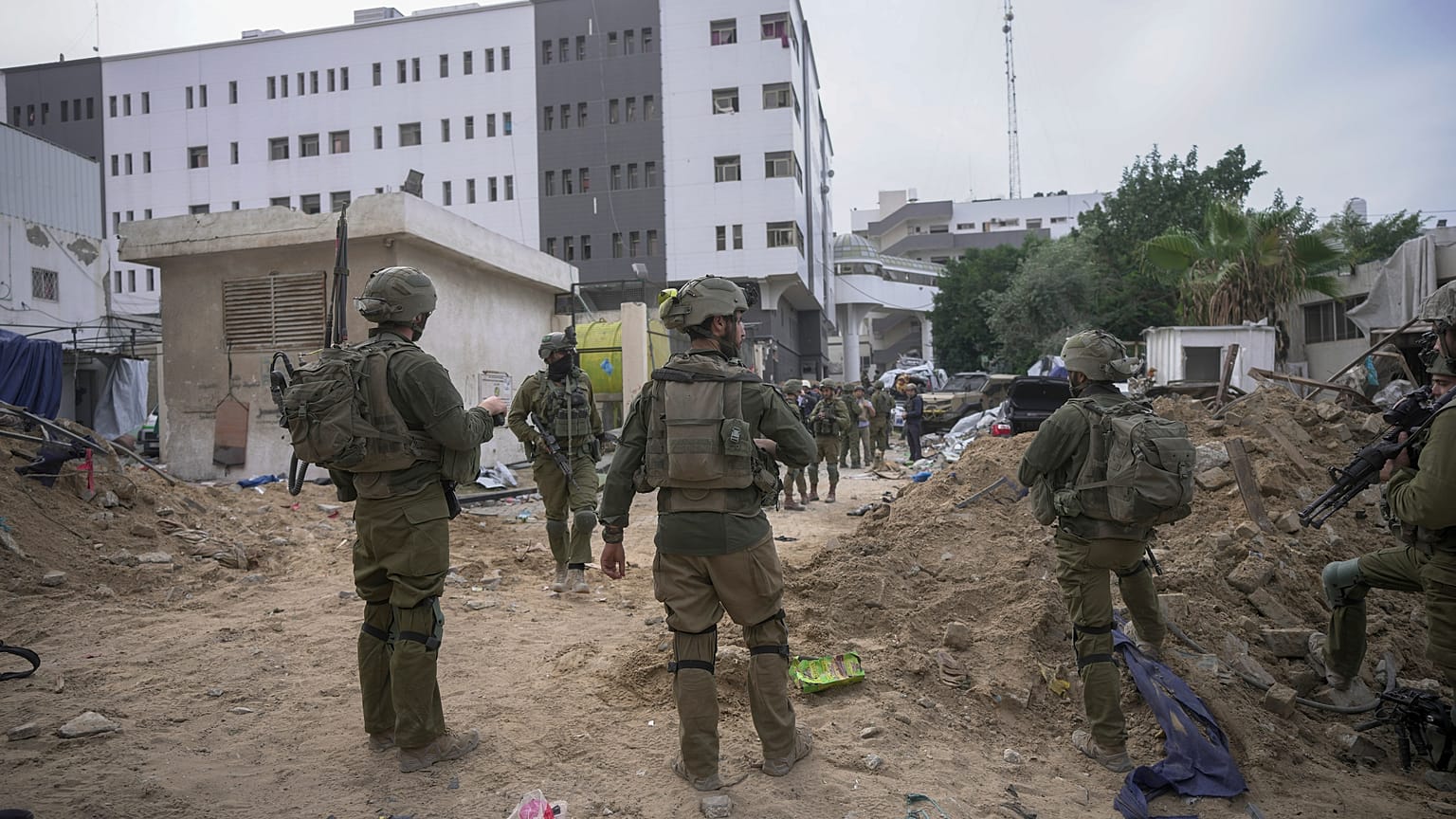 Israeli soldiers stand outside Shifa Hospital in Gaza City.