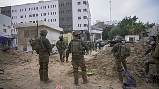 Israeli soldiers stand outside Shifa Hospital in Gaza City.