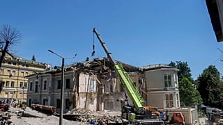 Rescue workers clear the rubble at the site of Okhmatdyt children's hospital hit by Russian missiles on Monday.