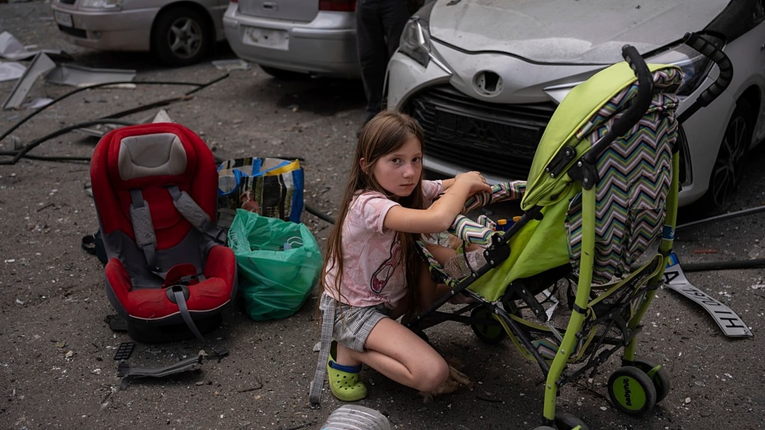 Polina, 10 anos, cuida da sua irmã Marina, 3 anos, no local do hospital pediátrico Okhmatdyt atingido por mísseis russos, em Kiev, Ucrânia, segunda-feira, 8 de julho de 2024 (AP Photo/Alex Baben)