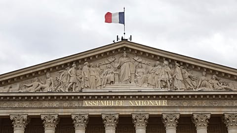 The French flag flies atop the National Assembly during the second round of the legislative elections, Sunday, July 7, 2024 in Paris