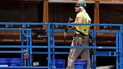 A worker uses a towel for protection from the sun