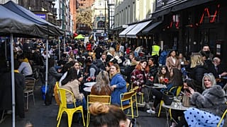 People outside cafes and pubs in Soho, central London, UK. April 12, 2021.