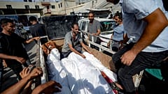Palestinians gather near the bodies of their relatives killed in the Israeli bombardment of the Gaza Strip, at a hospital morgue in Deir al-Balah, Saturday, July 13, 2024.