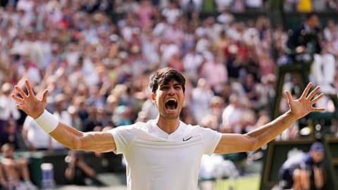 Carlos Alcaraz of Spain celebrates after defeating Novak Djokovic of Serbia during the men's singles final at the Wimbledon tennis championships in London, Sunday, July 14.