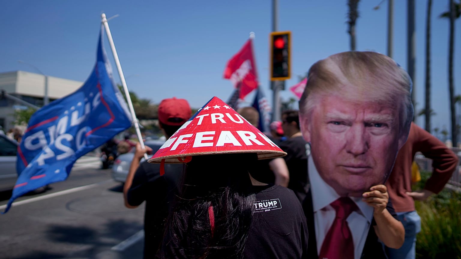 People rally in support of Republican presidential candidate former President Donald Trump in Huntington Beach, Calif., Sunday, July 14, 2024. (AP Photo/Eric Thayer)