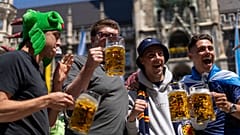 Scotland's football team fans drink beer in 'Marienplatz' square next to the town hall in downtown, Munich , Germany, Thursday, June 13, 2024. 