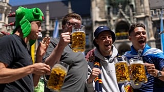 Scotland's football team fans drink beer in 'Marienplatz' square next to the town hall in downtown, Munich , Germany, Thursday, June 13, 2024. 
