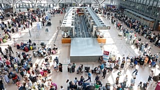 Travelers wait in Terminal 1 for check-in at Hamburg Airport, in Hamburg, Germany, Friday July 19, 2024. 