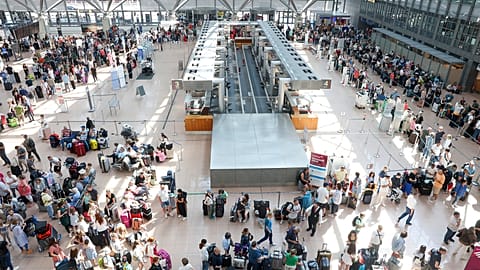 Travelers wait in Terminal 1 for check-in at Hamburg Airport, in Hamburg, Germany, Friday July 19, 2024. 