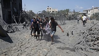 Filistinliler, Han Yunus'ta İsrail bombardımanı sırasında hayatını kaybeden bir sivilin bedenini taşıyor, 13 Temmuz 2024