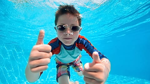 Being hydrated is much more important than not eating before going swimming.