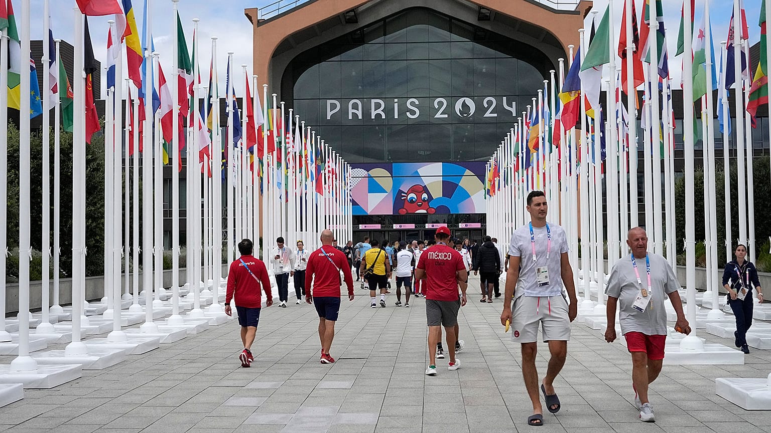 People walk in front of the canteen in the Olympic Village, at the 2024 Summer Olympics in Paris, 22 July 2024