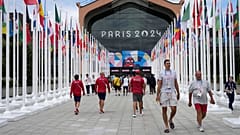 People walk in front of the canteen in the Olympic Village, at the 2024 Summer Olympics in Paris, 22 July 2024