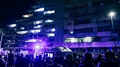 People gather in front of a building where a pedestrian walkway in a massive housing project collapsed in the southern Italian city of Naples, Tuesday, 23,2024.