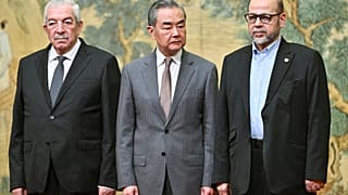 China's Foreign Minister Wang Yi, Mahmoud al-Aloul, vice chairman of Fatah, and Mussa Abu Marzuk, a senior member of Hamas