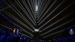 The Olympic rings are illuminated as lights emanate from the Eiffel Tower at the Trocadero during the opening ceremony for the 2024 Summer Olympics in Paris, France