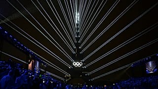 The Olympic rings are illuminated as lights emanate from the Eiffel Tower at the Trocadero during the opening ceremony for the 2024 Summer Olympics in Paris, France