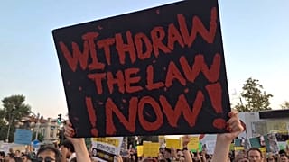 A protester holds up a sign at a demonstration in Istanbul against a proposed bill to reduce stray dog numbers, July 27, 2024