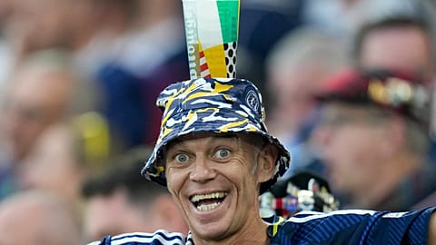 A Scotland fan balances a beer cup on his head before a Group A match between Scotland and Hungary at the Euro 2024 soccer tournament in Stuttgart, Germany