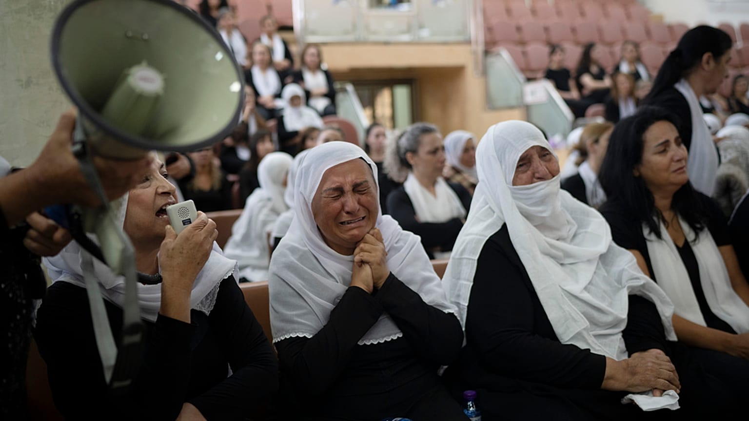 Des membres de la minorité druze assistent à une cérémonie à la mémoire des enfants et des adolescents tués lors d'un tir de roquette dans le village de Majdal Shams (AP Photo/Leo Correa).