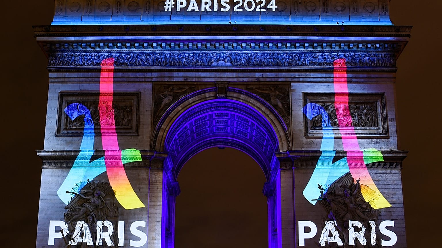 2024 Paris Olympics logo displayed on Arc de Triomphe