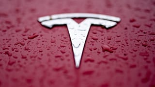 A Tesla logo is shown