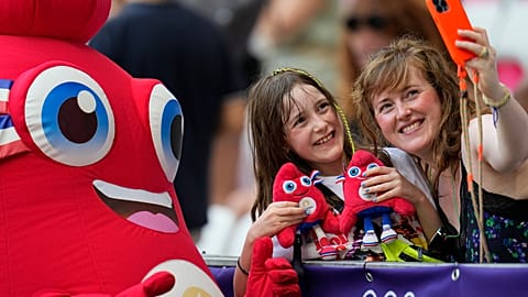 Phryge, the mascot of the Paris 2024 Olympic Games poses for a selfie with fans at the 2024 Summer Olympics, Sunday, July 28, 2024, in Nice, France.