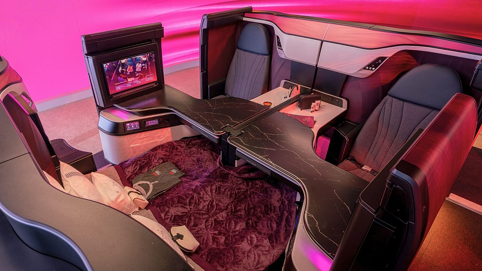 Qatar Airways' Qsuite Next Gen suites feature fold-back TV screens.