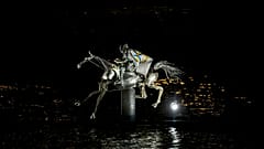 A performer on a mechanical horse carries the Olympic flag down the river Seine in Paris, France, during the opening ceremony of the 2024 Summer Olympics, July 26, 2024.