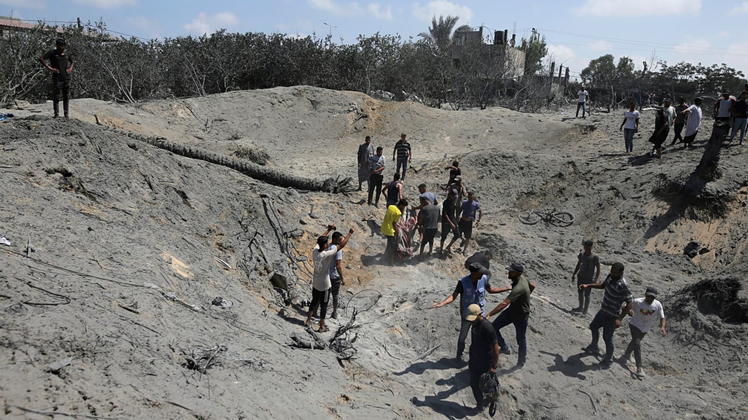 Palestinians search for bodies and survivors in a site hit by an Israeli bombardment on Khan Younis, southern Gaza Strip, Saturday, July 13, 2024.