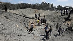 Palestinians search for bodies and survivors in a site hit by an Israeli bombardment on Khan Younis, southern Gaza Strip, Saturday, July 13, 2024.