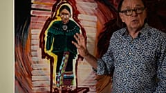 Joe Baker, a member of the Delaware Tribe of Indians and co-founder of the Lenape Center stands next to a painting of an Ohtas during an interview in his home in New York.