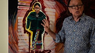 Joe Baker, a member of the Delaware Tribe of Indians and co-founder of the Lenape Center stands next to a painting of an Ohtas during an interview in his home in New York.