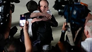 Reporter Evan Gershkovich receives an embrace from a colleague following his release as part of a 24-person prisoner swap between Russia and the United States on 01/08/2024