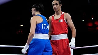 Algeria's Imane Khelif, right, walks beside Italy's Angela Carini after their women's 66kg preliminary boxing match at the 2024 Summer Olympics