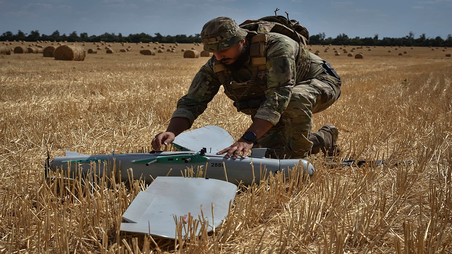 A soldier of Ukraine's National Guard 15th Brigade works with a reconnaissance drone Leleka on a wheat field to determine Russian positions near the front line in Zaporizhzhia