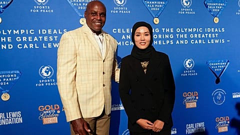 Former Olympian Carl Lewis, left, and representer of the IOC's Refugee Olympic Team Masomah Ali Zada arrives for the Sport for Peace Gala in Paris on Saturday
